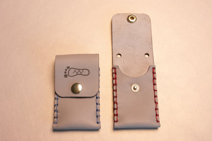 Two Grey leather sewn thumb drive necklace.