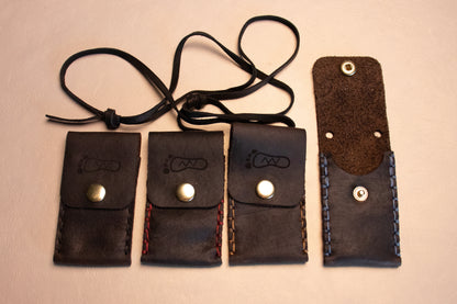 Four brown leather sewn thumb drive necklace.