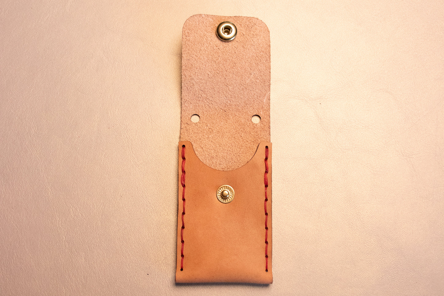 Open Natural vegetable tanned leather sewn thumb drive necklace.