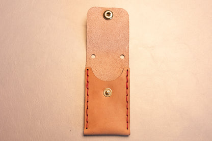 Open Natural vegetable tanned leather sewn thumb drive necklace.